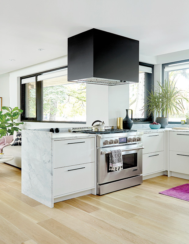 Light and airy modern kitchen with a dramatic black vent.
