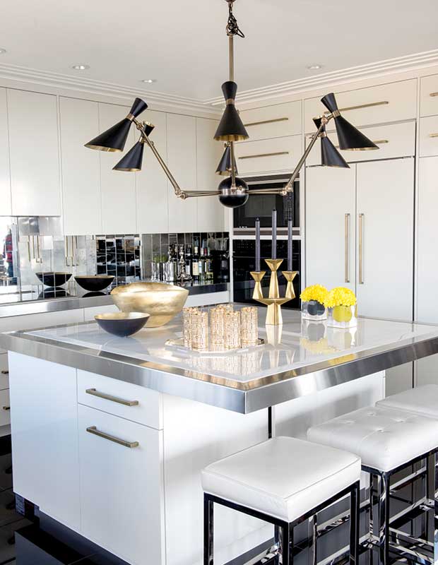 Sleek white kitchen with accent chandelier