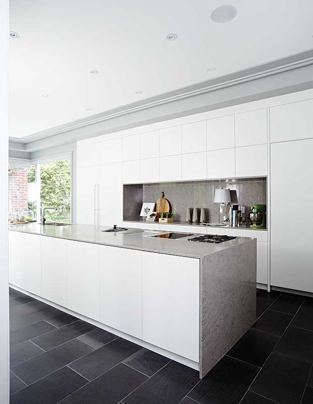 Sleek white kitchen with long island.