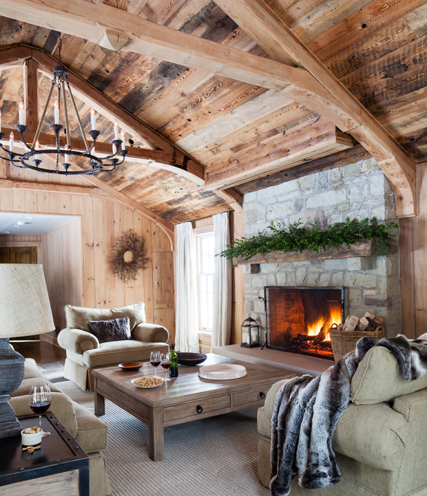 A warm living room with wood-panelled walls and ceiling.