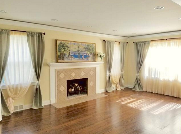 2-oprah-home-living-room-with-fireplace-and-painting-on-mantle