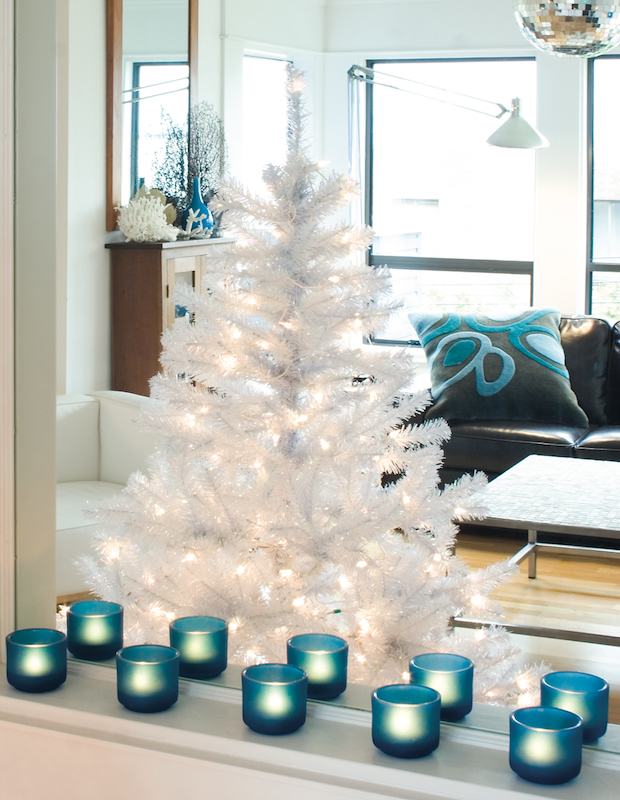 Bare white Christmas tree in a blue accented room.