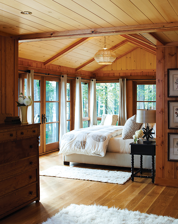 This cozy Canadiana lodge is the perfect fall getaway with its rich wood, fuzzy rugs and exposed beams in the master bedroom