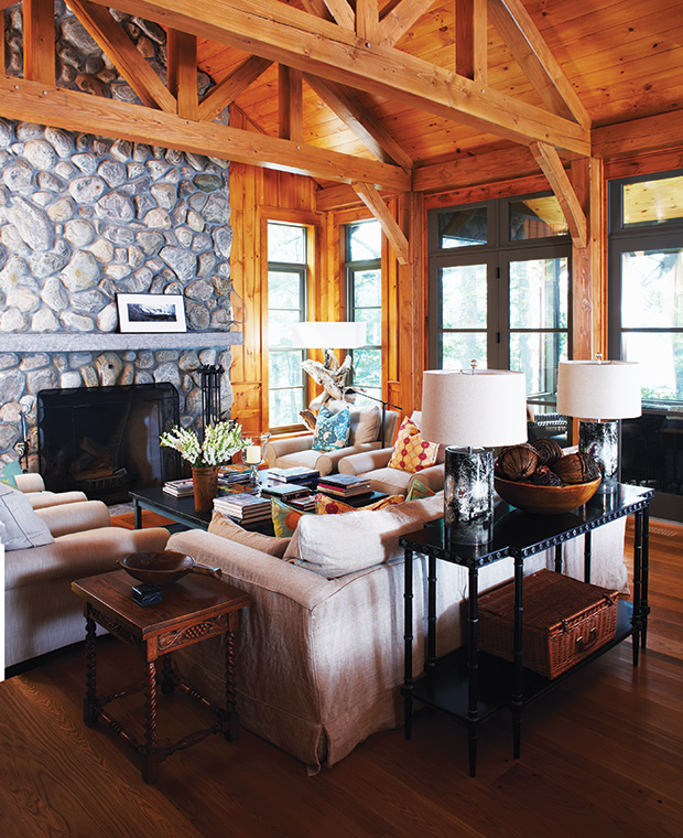 This cozy Canadiana lodge is the perfect fall getaway with its rich wood, stone fireplace and inviting atmosphere in the living room