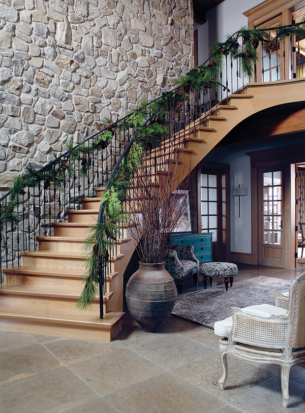 A white oak staircase with lush greenery decor.