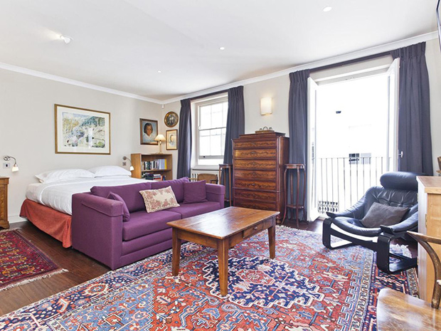 Madonna's London mews principal bedroom with colourful rugs.
