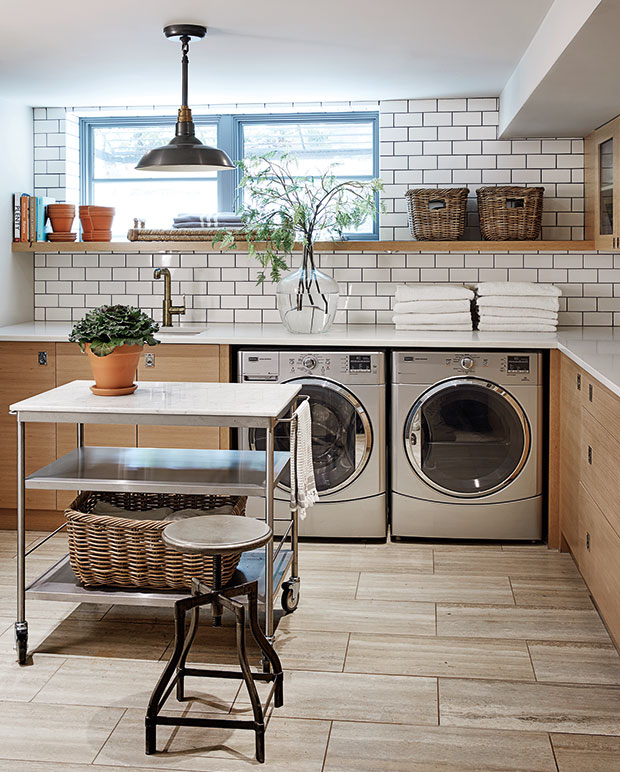 Nam Dang-Mitchell's laundry room with wood cabinetry and subway tile backsplash.