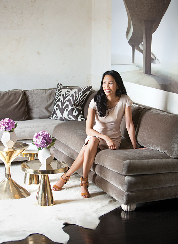 Nam Dang-Mitchell in her Calgary home with luxurious seating and gold accent tables.