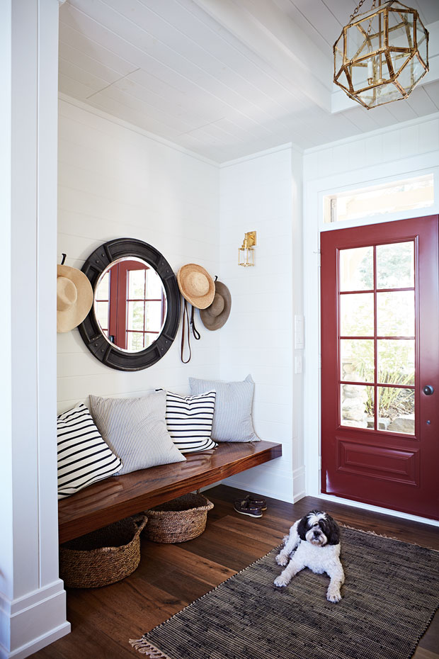 The entryway in a fall getaway with a bright red door