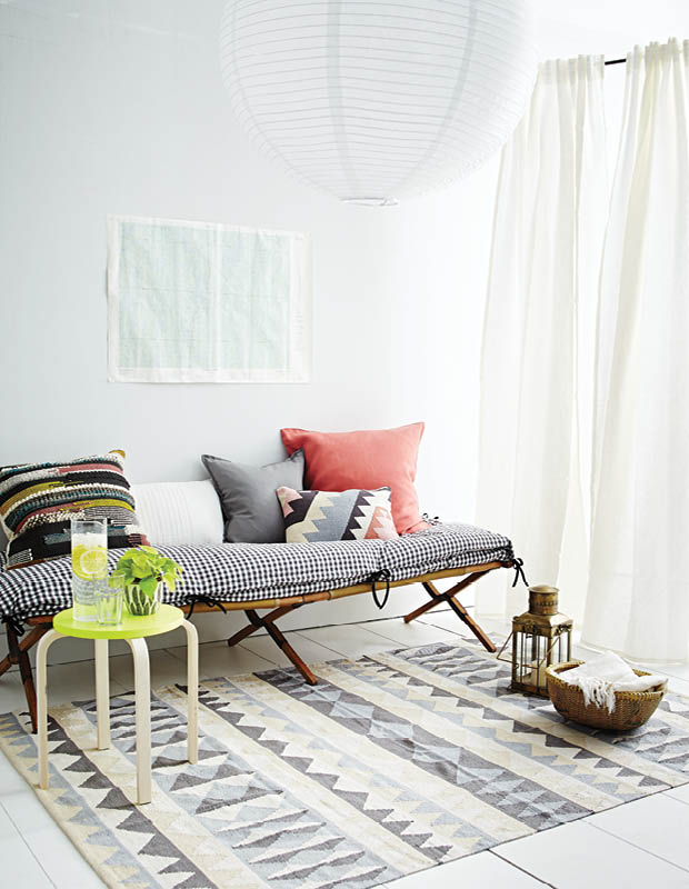 A gingham day bed with colourful pillows