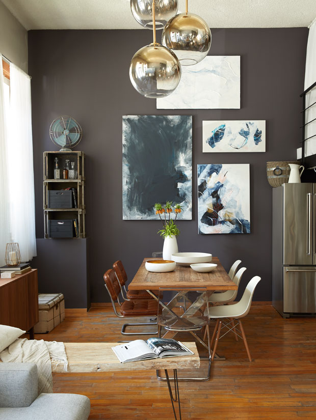 Amelie Simard's Montreal loft dining room with a moody gallery wall