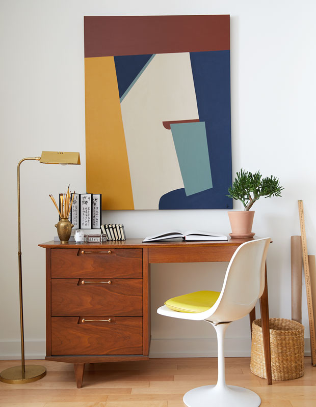 Valérie Morisset's office with a yellow-accent tulip chair.