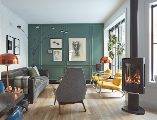 Living area with soft green wall and Scandinavian fireplace