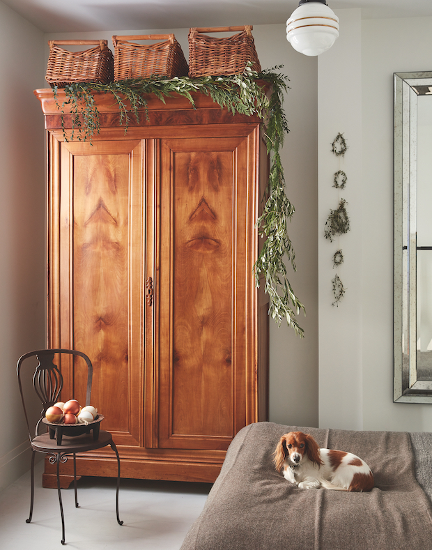 Wood armoire decorated with greenery