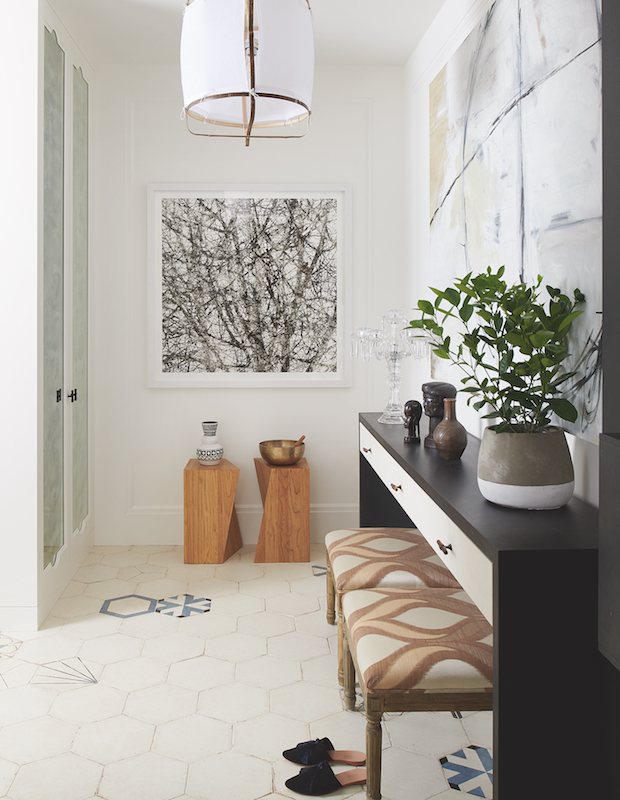Sophisticated entryway with artwork and wood features
