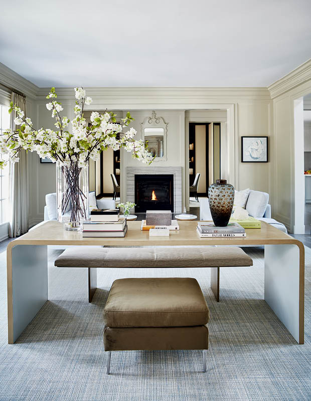 A library-style desk separates the living room's two seating areas.