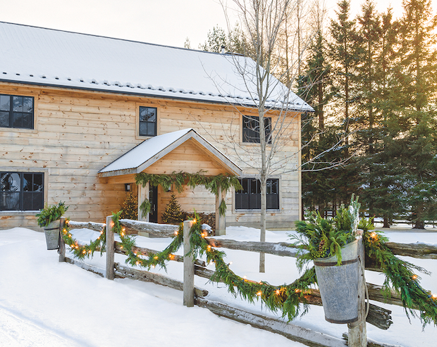 Rustic home exterior with wood and hanging greenery