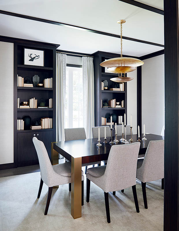 2018 Princess Margaret Showhome dining room with floor-to-ceiling bookcases and dark wood features.