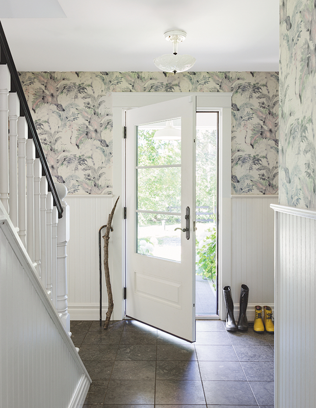 Serene entryway with wallpapered walls and white wood panels