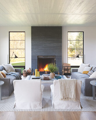 Living room designed by Mazen El-Abdallah with accent fireplace and warm features.