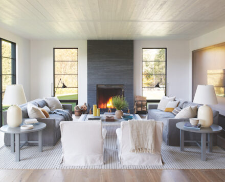 Living room designed by Mazen El-Abdallah with accent fireplace and warm features.
