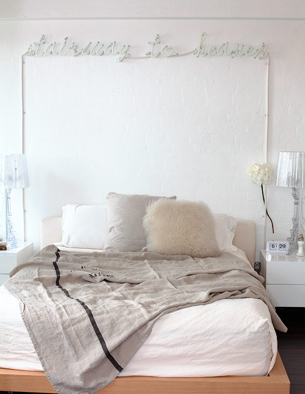 White bedroom with plush bedding.