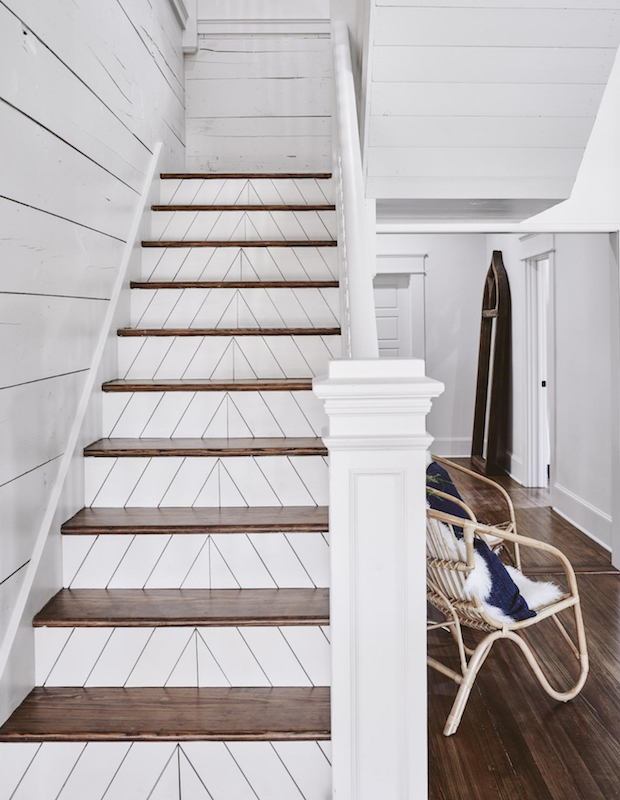 White staircase with patterned wood steps.