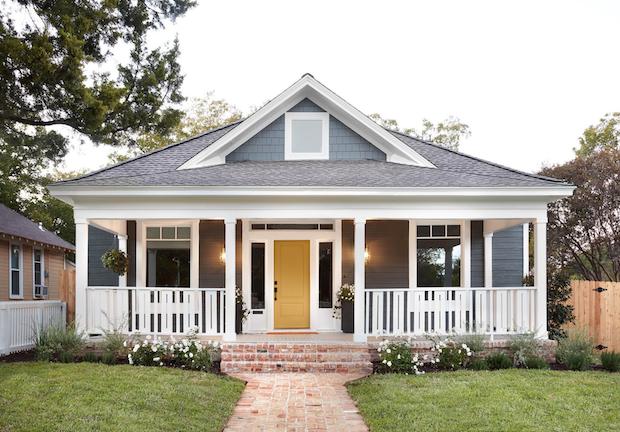 Moody home exterior with bright front door