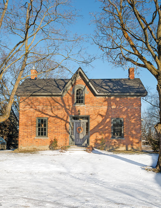 Holiday curb appeal — a handsome house with an orange-hued wreath to match the home's brick exterior