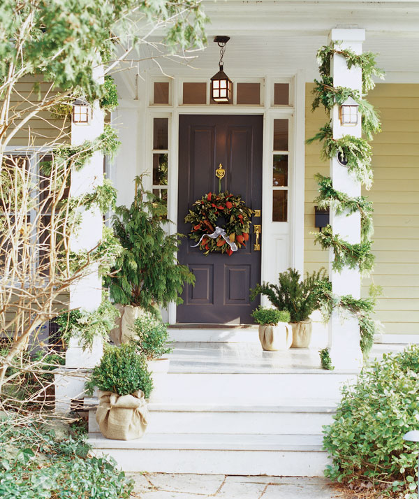 holiday curb appeal ideas - a festive front door with lots of greenery