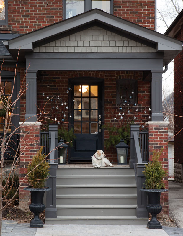 Holiday curb appeal — a home with ornaments on a naked tree