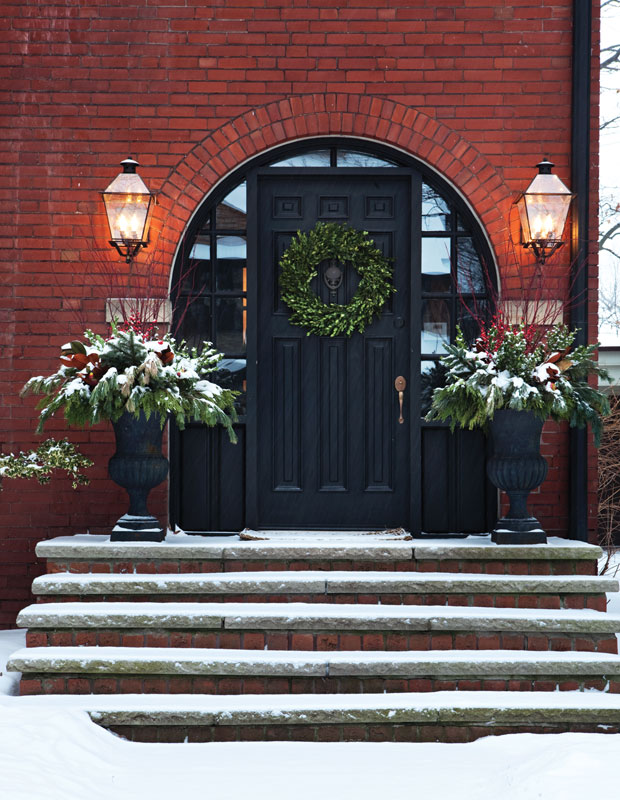 Holiday curb appeal — a handsome front door with red brick and greenery
