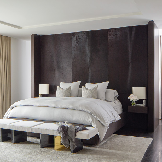 Julie Charbonneau master bedroom with a neutral palette and pony hide headboard