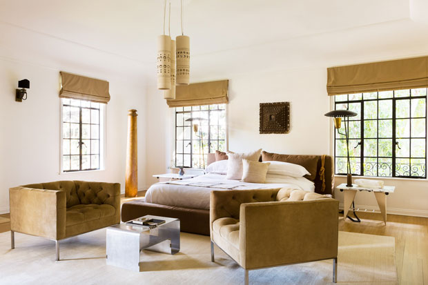 Nate Berkus and Jeremiah Brent master bedroom with earthy tones and quilted chairs