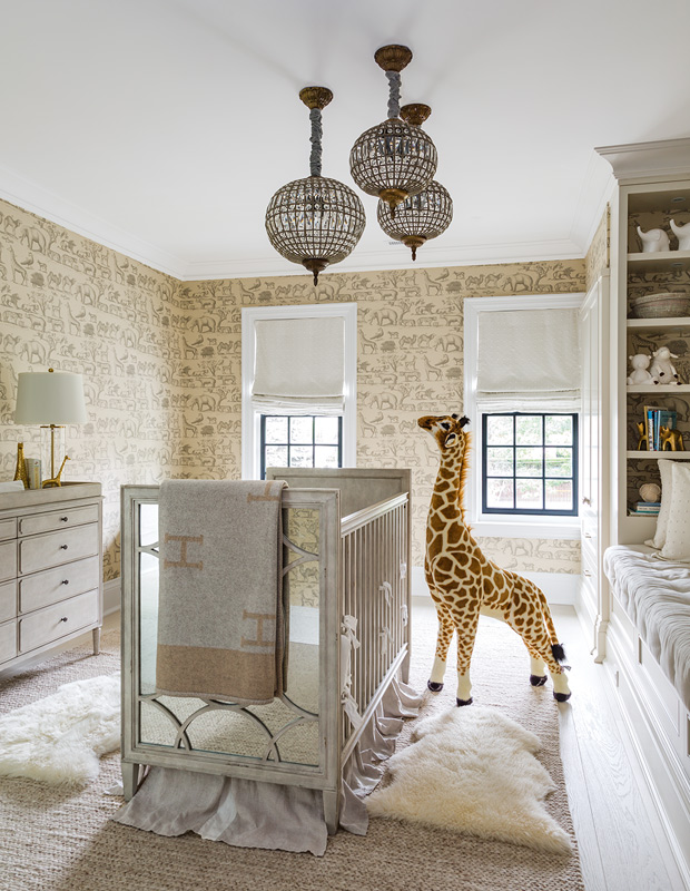 Organized family homes nursery with animal print wallpaper and warm tones