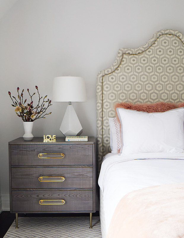 Anne Hepfer global family home guest bedroom with a patterned headboard and plush bedding