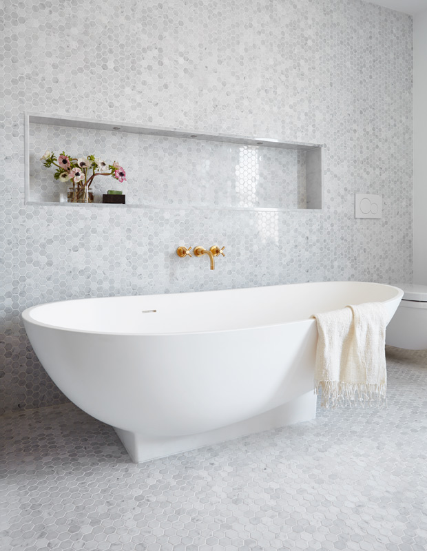 Minimalist spaces bathroom with hexagon tiles and a stand-alone tub