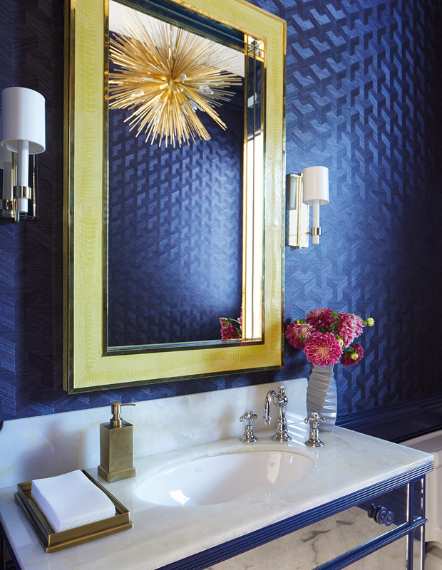 Anne Hepfer global family home powder room with a statement gold light fixture and textured blue wallpaper