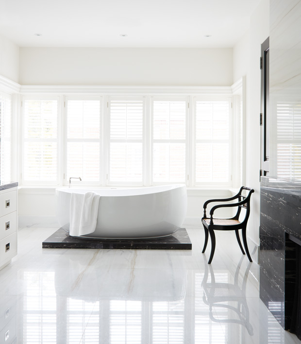 Minimalist spaces bathroom with high-gloss marble floors and a stand-alone tub