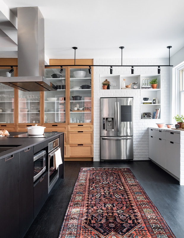 Eclectic kitchen with a mix of industrial and traditional styles and an eye-catching rug