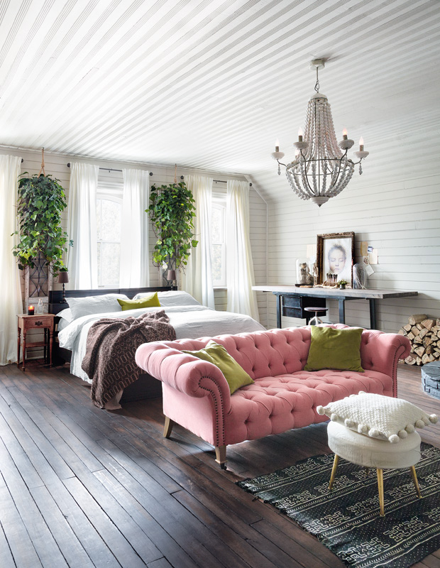 Designer Elle Patille bedroom with pink tufted chair, fresh greenery and rich hardwood floors