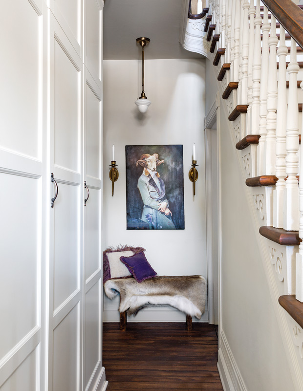 Designer Elle Patille entryway with an animal painting and petite bench