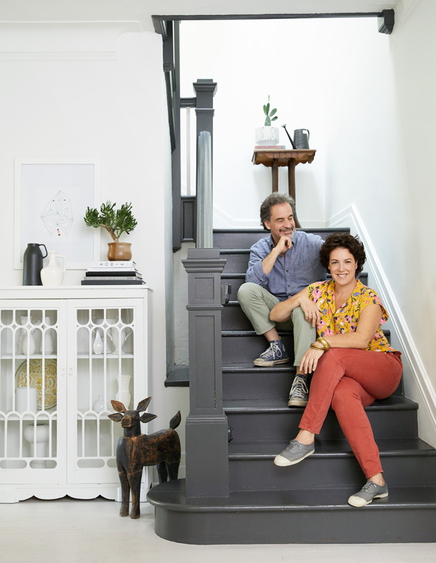 Organized family homes couple sitting on the stairs
