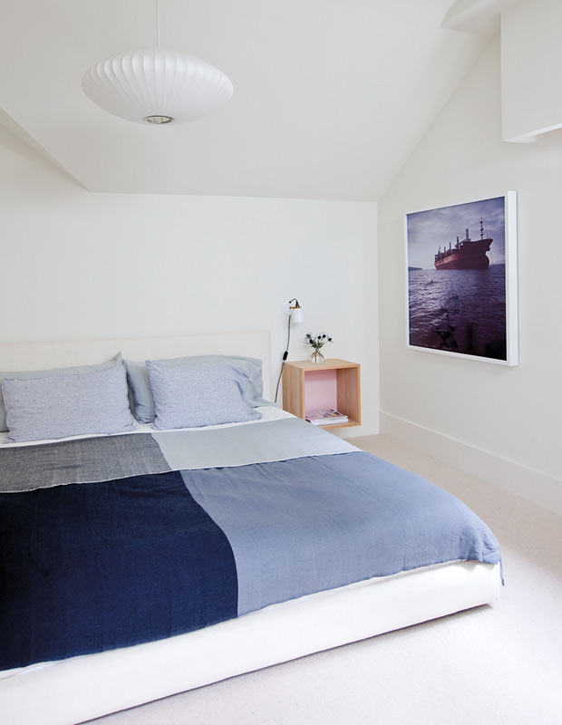Minimalist spaces bedroom with sparse accessories and a blue comforter