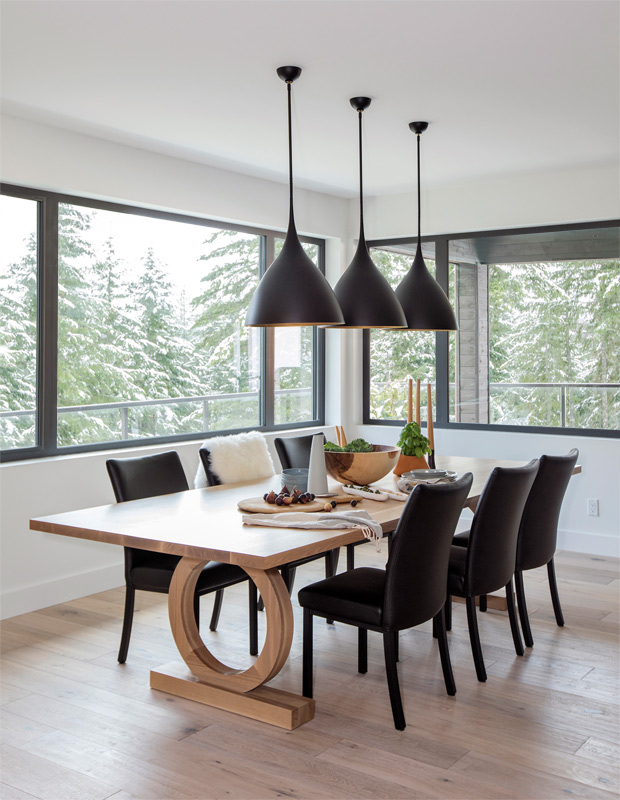 Ami McKay Whistler family home dining room with graphic pendants and inky chairs