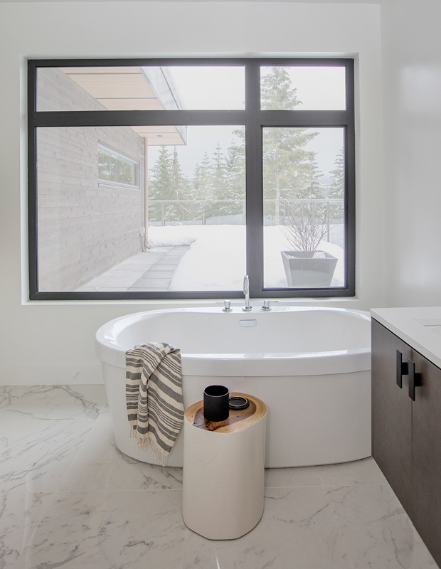 Minimalist spaces bathroom with marble floors and white tub
