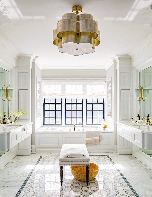 Beautiful bathrooms with a bold buttery brass pendant and luxurious feel