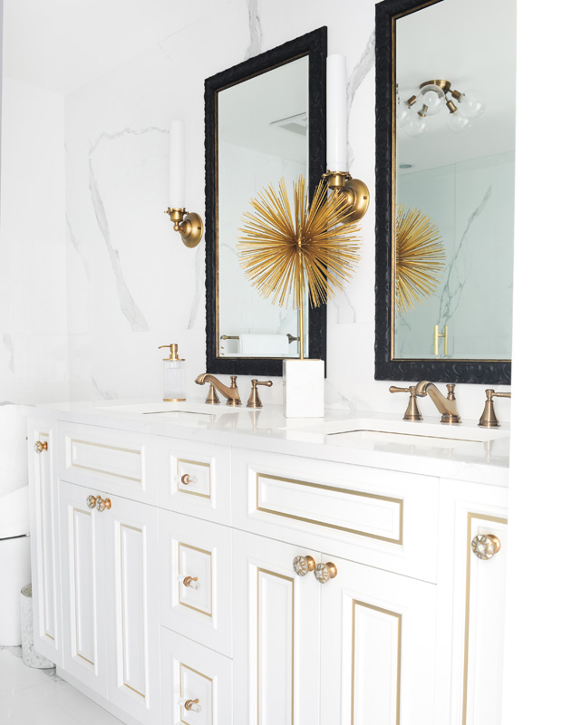 Beautiful bathrooms with a spiky brass sculpture and marble walls