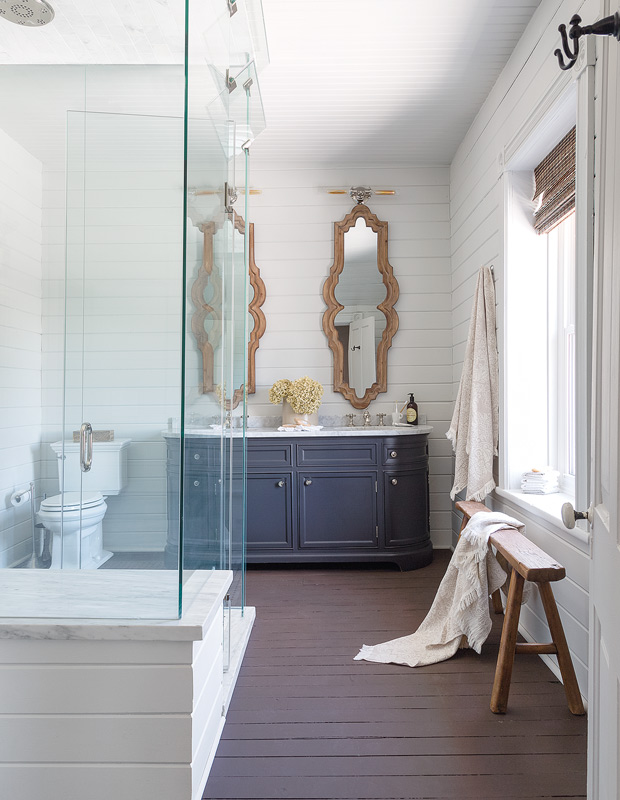 Beautiful bathrooms with vintage-inspired mirrors and a moody vanity