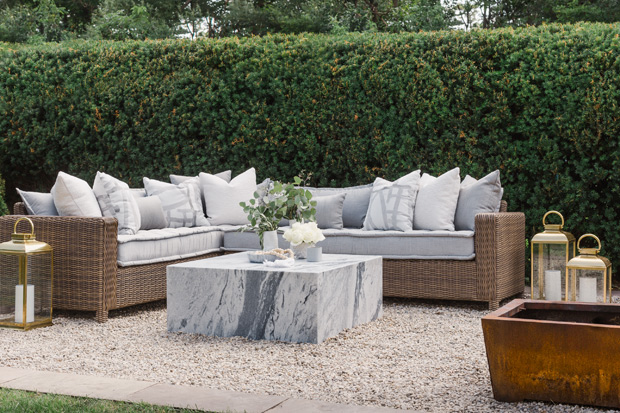 Sarah Walker backyard seating area with grey upholstery and gold lanterns